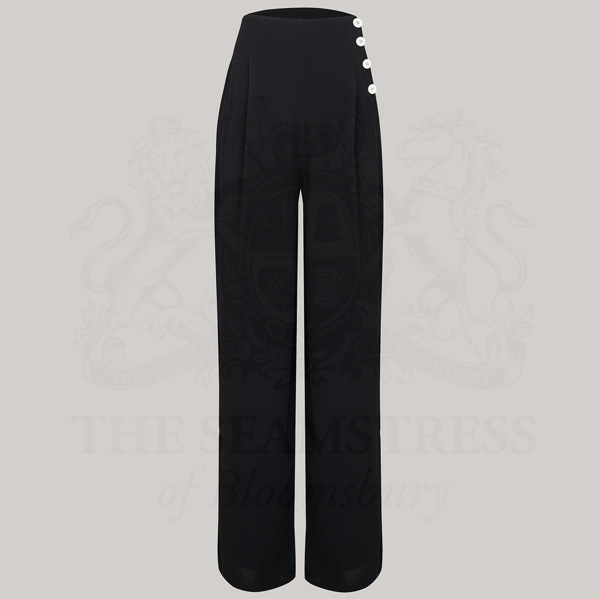 Wide-leg 1940s women’s trousers in black. Four decorative buttons are down the left from the waist with a hidden zip in the side seam. 