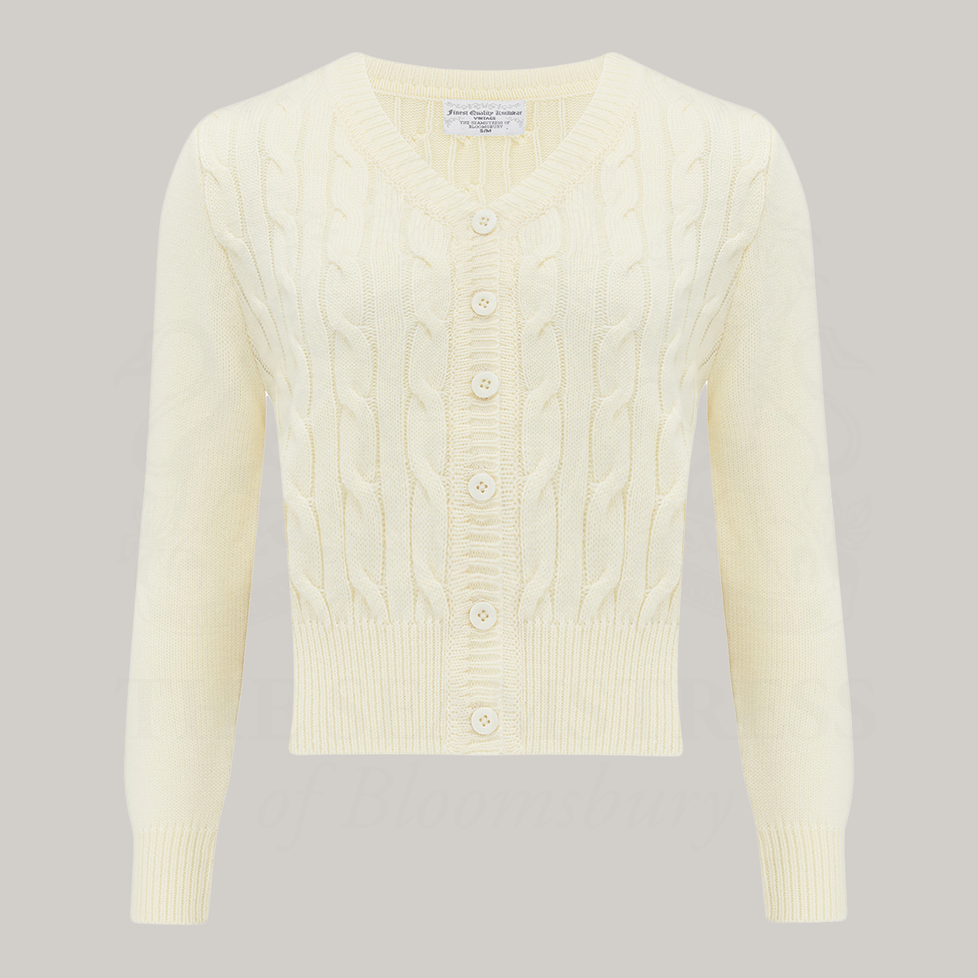 A 1940s style cable knitted cardigan in cream. Matching cream buttons feature down the front of the cardigan.